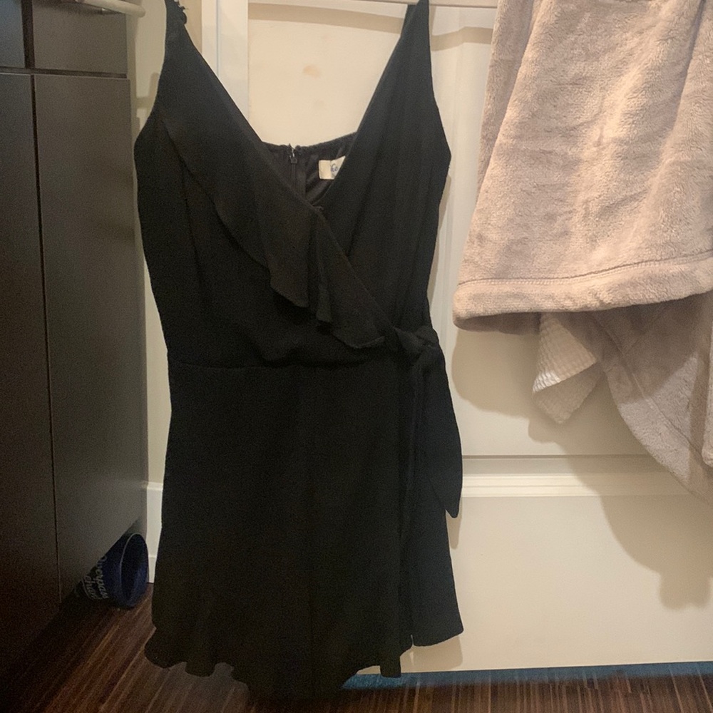 I’m selling the She + Sky Woven Cami black romper! Never been worn!